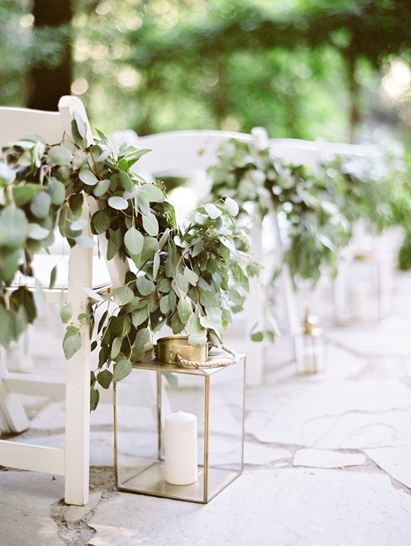 wedding aisle with lantern and greenery decorations