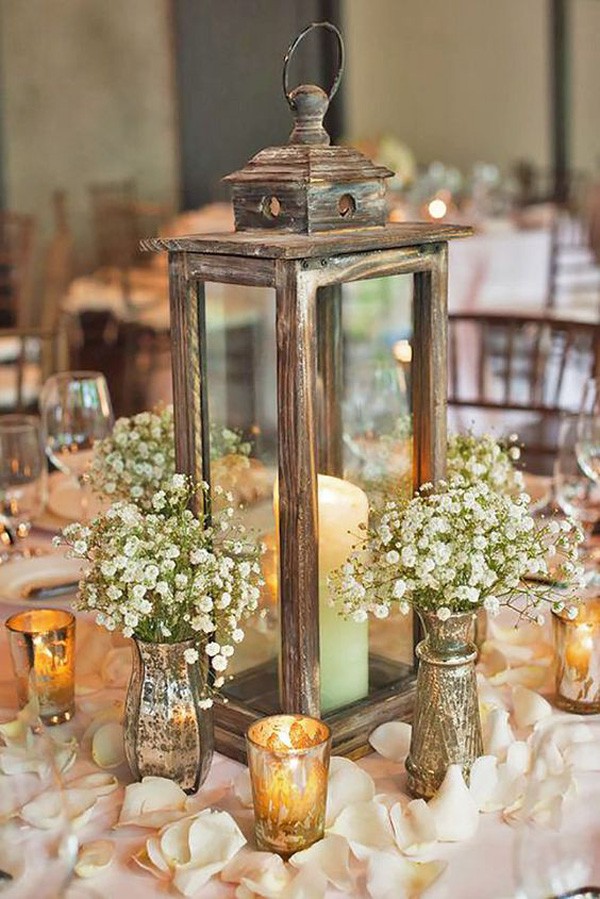 vintage lantern wedding centerpieces with candles and baby's breath