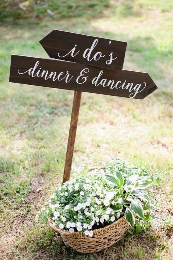 country rustic outdoor wedding sign with wildflowers