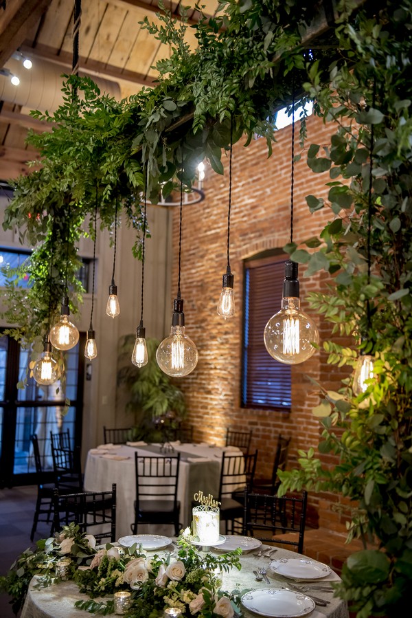 wedding table decorations with greenery and Edison bulbs