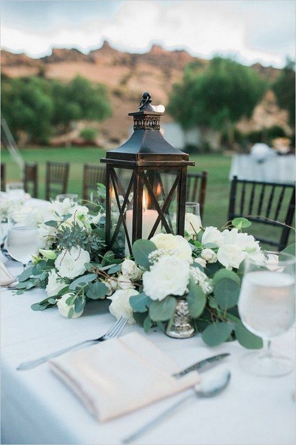 white and greenery wedding centerpiece with lantern
