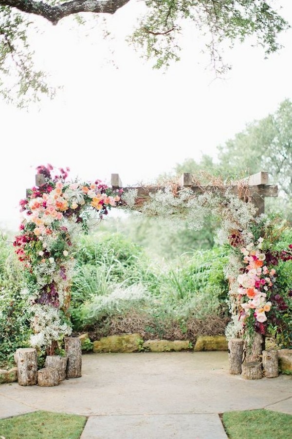 floral wedding arch ideas with tree stumps