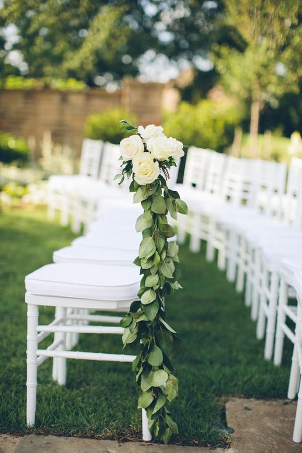 white ceremony chairs with green and white floral decorations