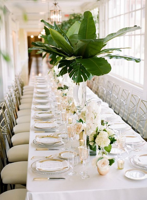 green and gold tropical wedding centerpiece with palm leaves