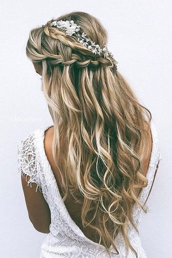 romantic half up half down wedding hairstyle with braids and baby's breath