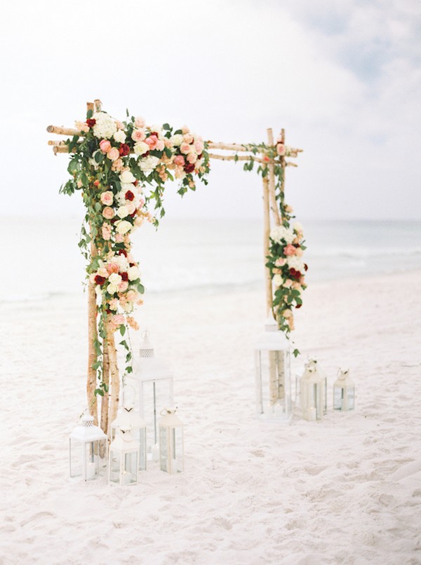 beach floral wedding arch with lanterns