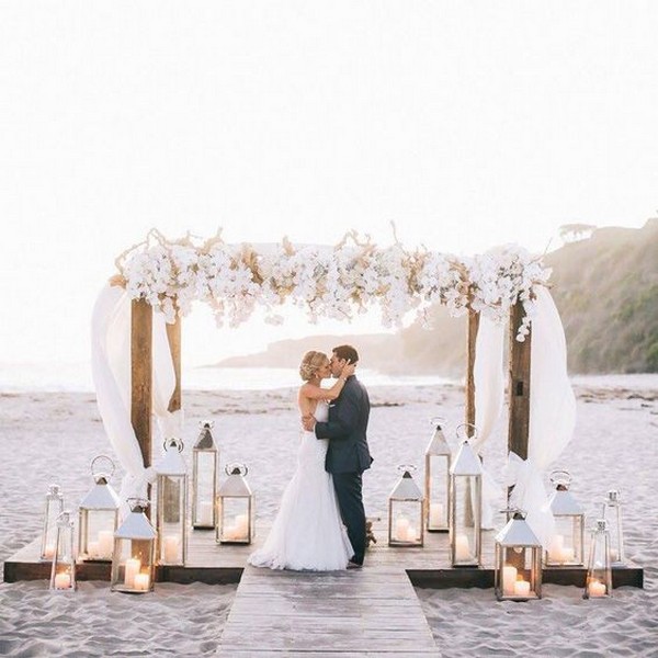 romantic floral beach wedding alter ideas with lanterns