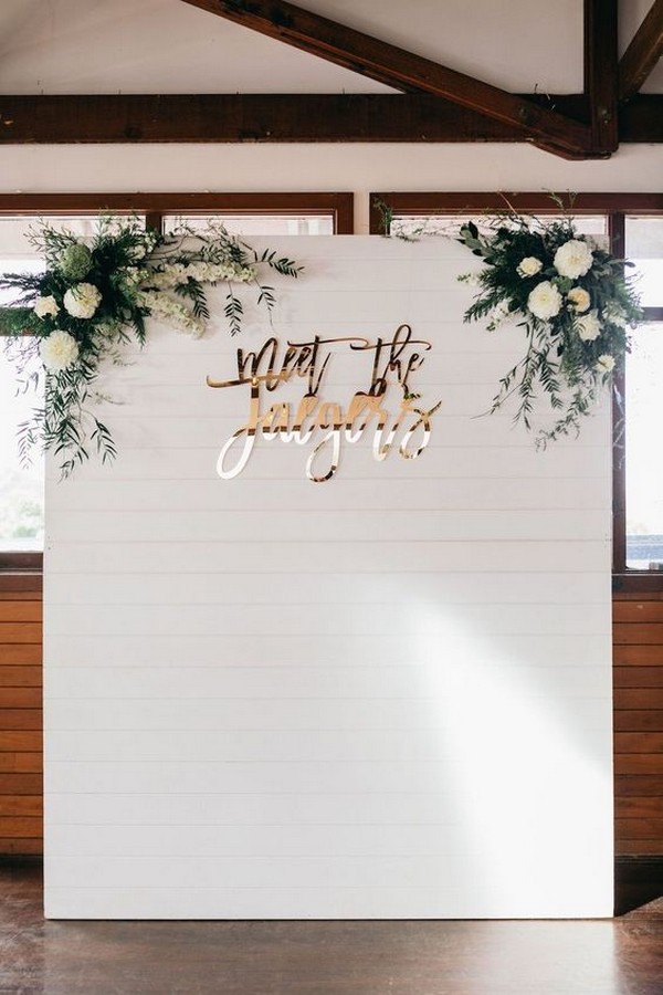 chic wedding photo booth backdrop ideas with white and green floral