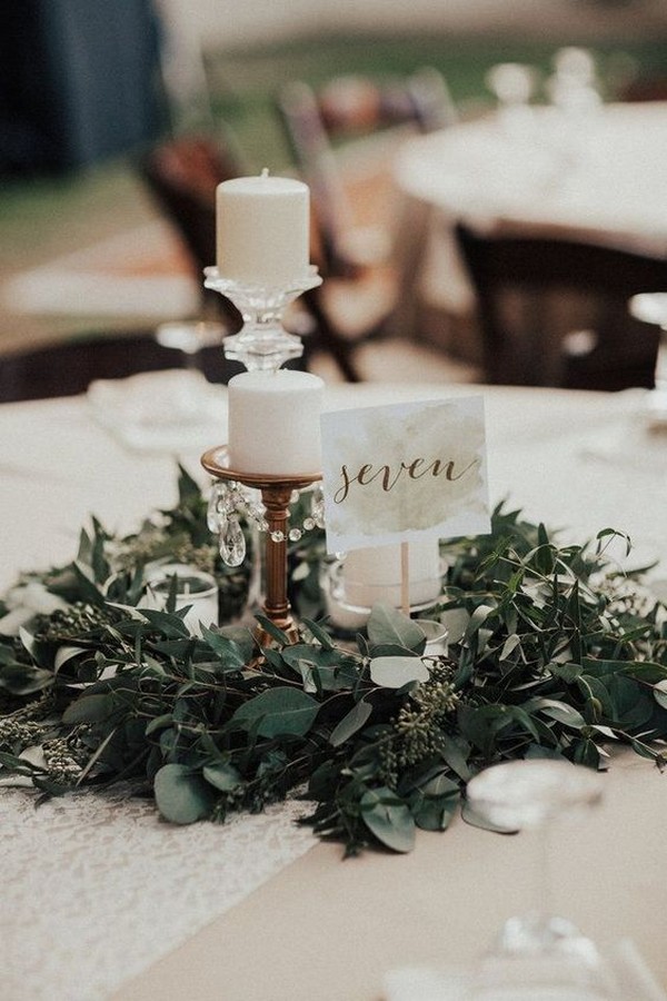 vintage wedding centerpiece with candles and greenery