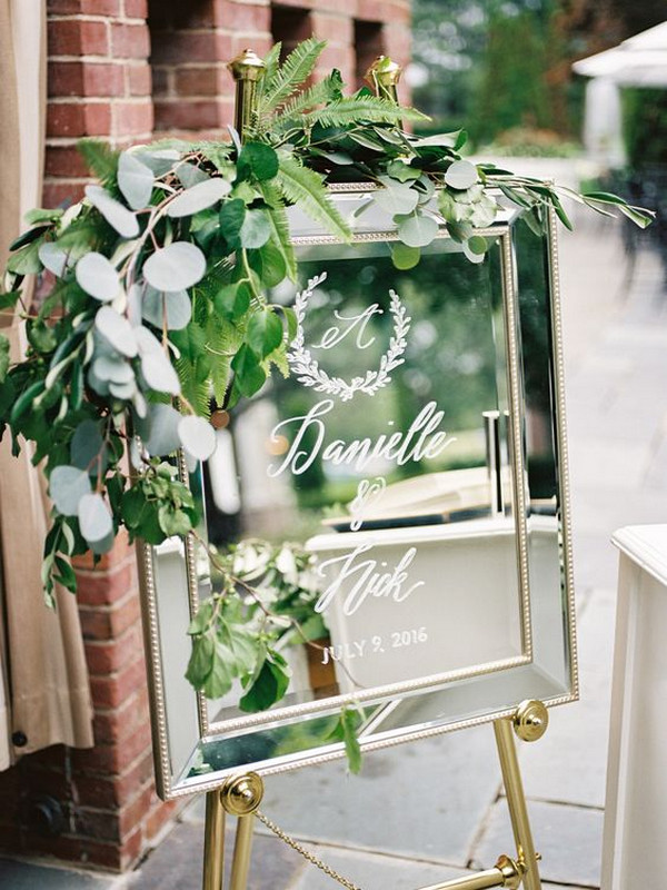 elegant mirror wedding sign with greenery