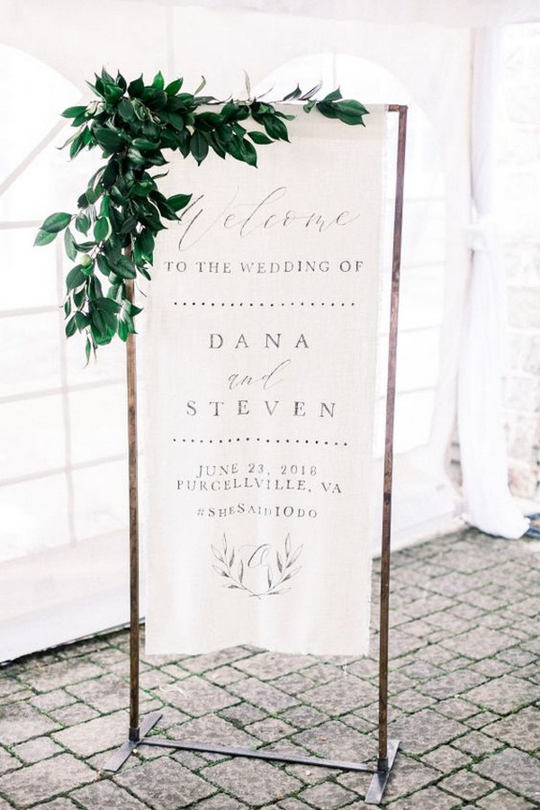 fabirc wedding welcome sign with greenery