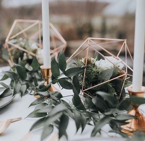 rose gold geometric wedding centerpiece with greenery and candles