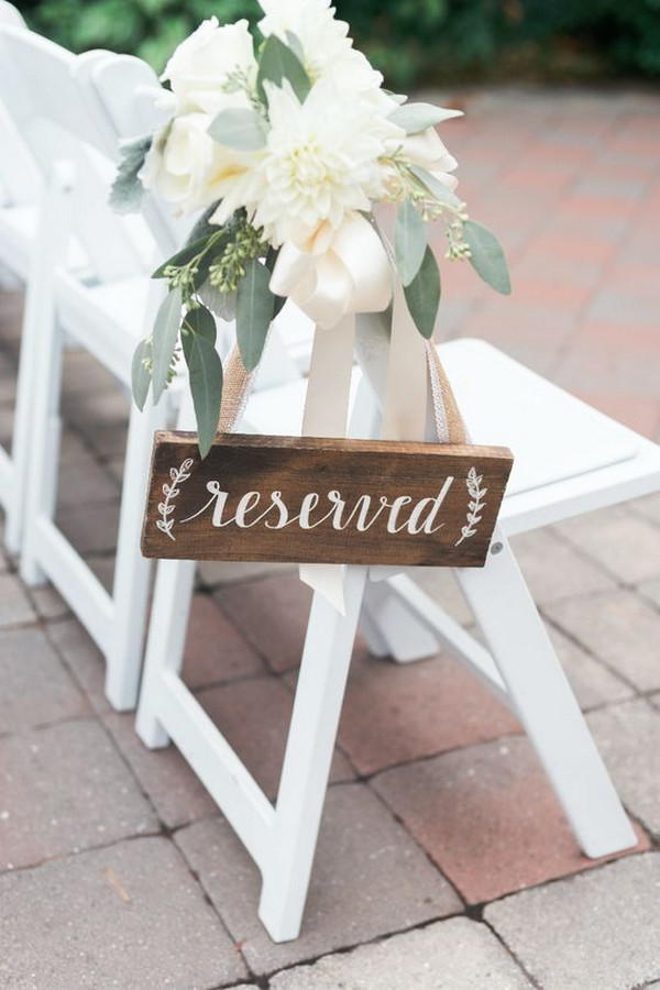Rustic wooden reserved sign for wedding ceremony
