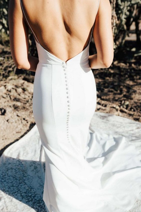 elegant wedding dress with open back and buttons down the train