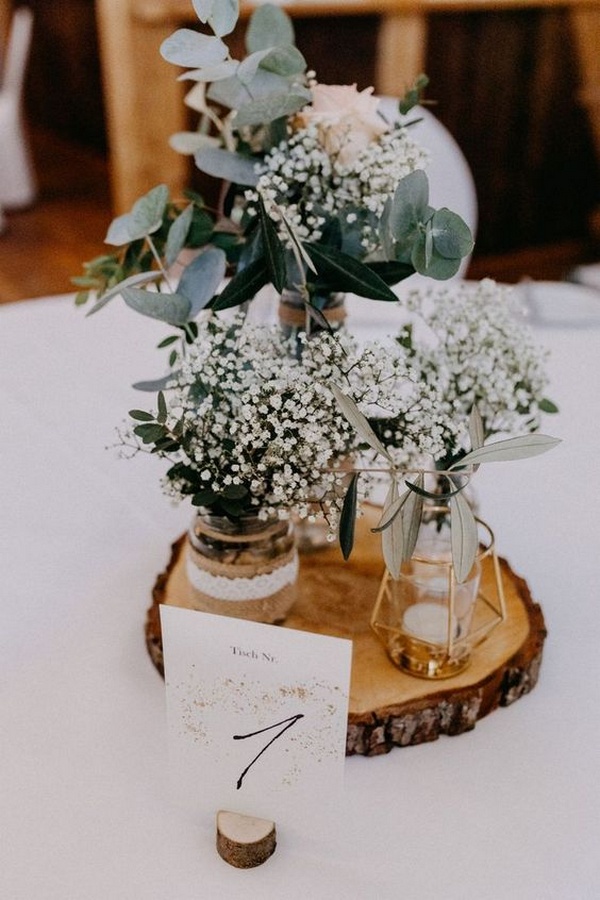baby's breath and tree stump rustic wedding centerpiece on a budget