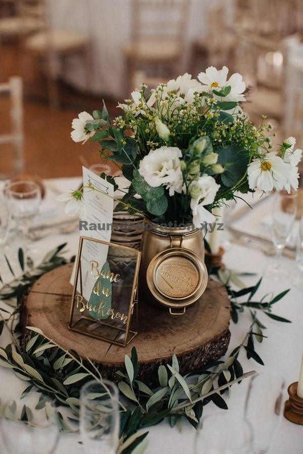 chic rustic wedding centerpiece with tree stump and greenery