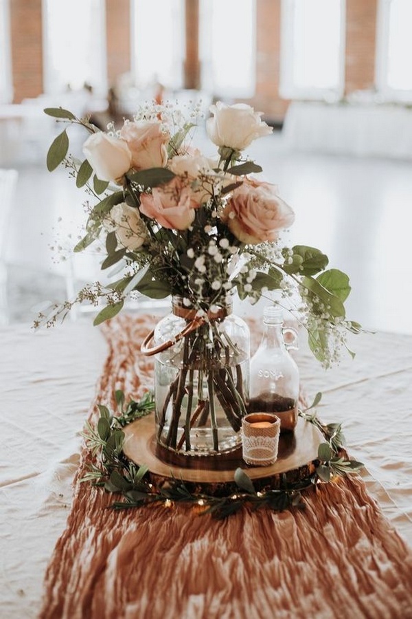 rustic wedding centerpiece with tree stump stand