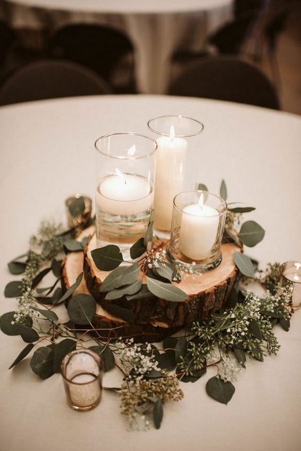 simple chic wedding centerpiece with candles and tree stumps