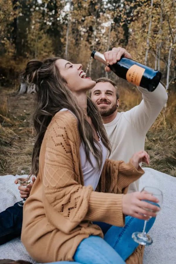 Pour some champagne into your partner's mouth for an incredible engagement shoot.