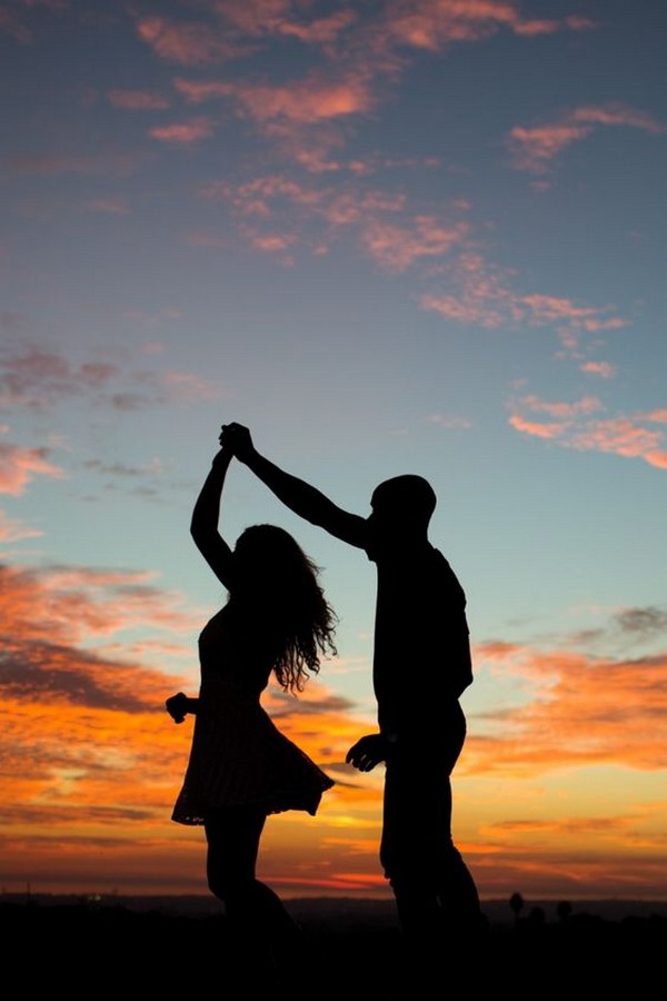 Picture of the engaged couple dancing into the sunset