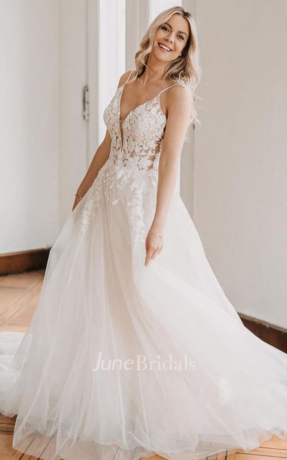 This exquisite A-line Mexican bridal dress features delicate lace and tulle fabrics, a fitting spaghetti V-neckline, and a beautiful floor-length skirt for a romantic bohemian vibe