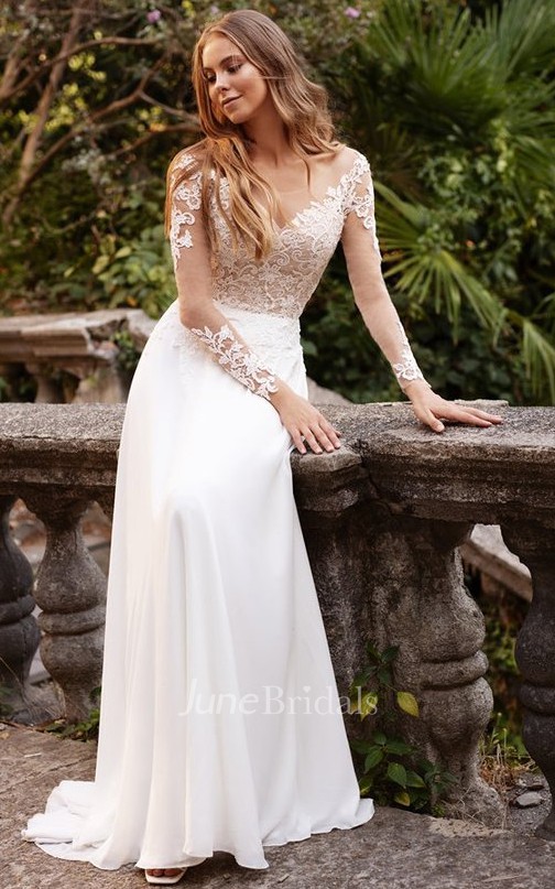 This vintage-inspired Mexican A-line wedding dress has a beautiful bateau neckline, long sleeves, and a sweeping train.