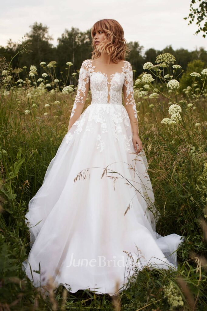 Charming Mexican wedding dress with tulle illusion sleeves, delicate lace details and a stunning illusion button back.