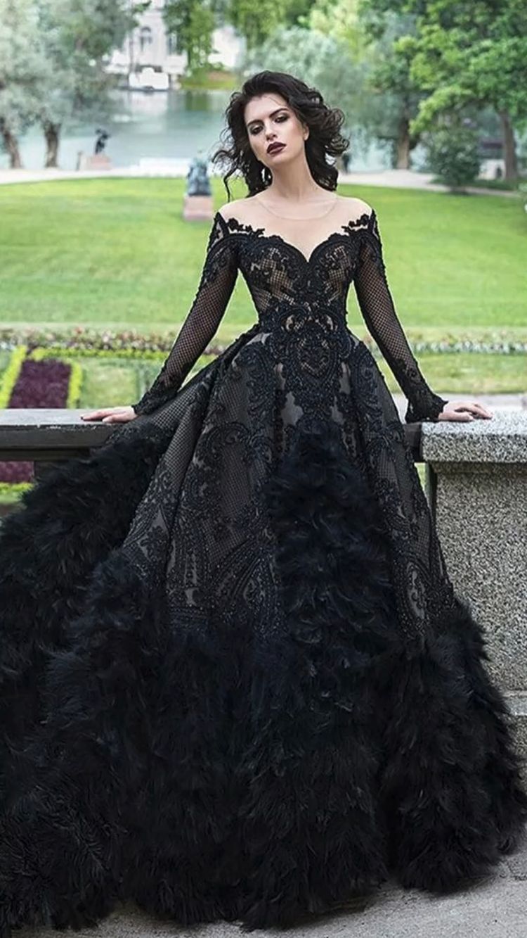 This dramatic lace black wedding dress embodies a seductive appeal for the unique boho bride, thanks to its breathtaking combination of bohemian and Gothic elements.