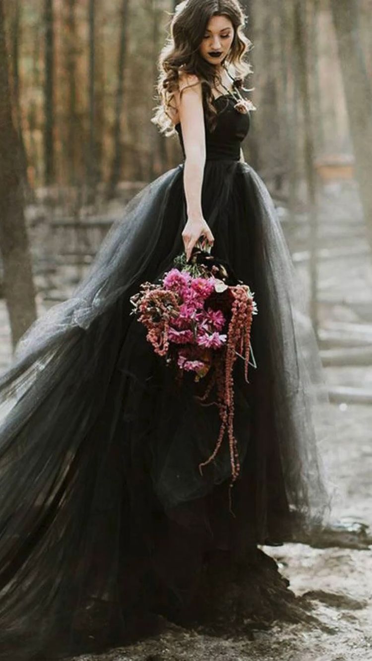 A beautiful black lace wedding dress and a colorful bouquet will unleash your inner gothic goddess.
