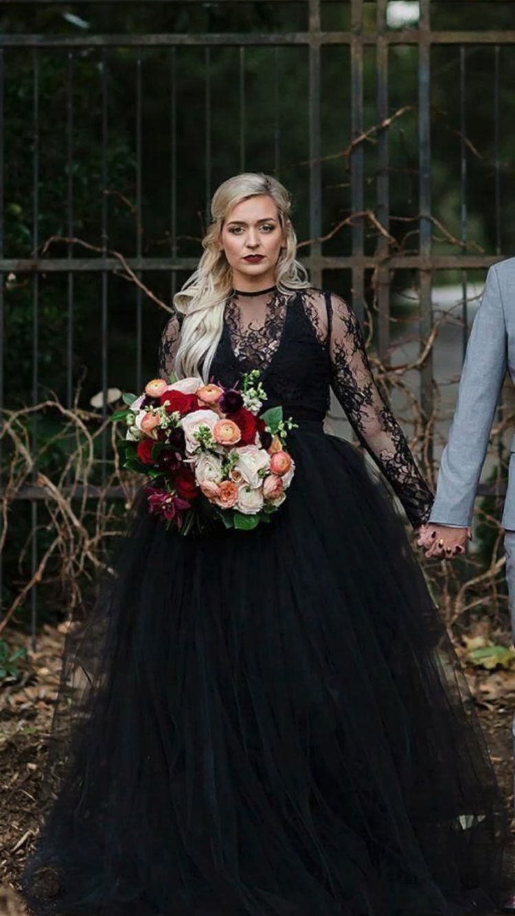 This bride’s bold, colorful bouquet stands out against the sophistication of her black lace wedding dress and adds a sense of fun and originality to her big day.