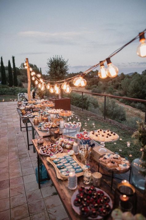 Wedding dessert bar with charcuterie and romantic lighting