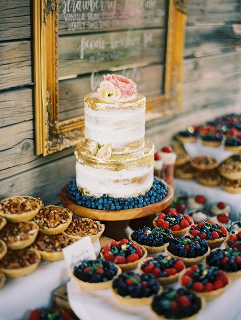 Colorful pies dessert bar display with two tiered cake 