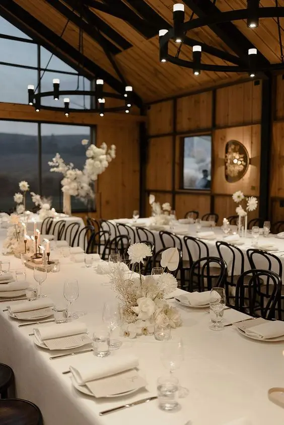 beautiful all neutral minimalist wedding tablescapes with white blooms white linens and menus candles are gorgeous