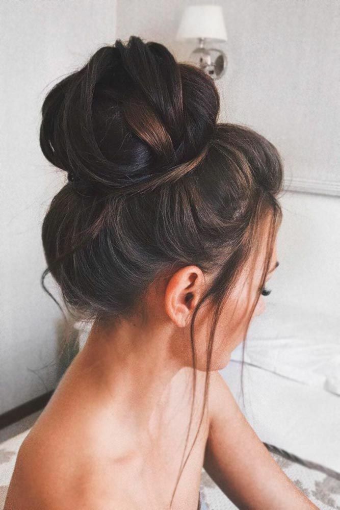 A high messy bun wedding hairstyle for medium hair is a great choice for a summer wedding.