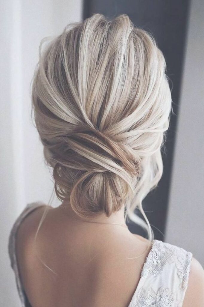 Twists add an interesting dimension to the low bun, making it a more unique and eye-catching hairstyle for medium hair.