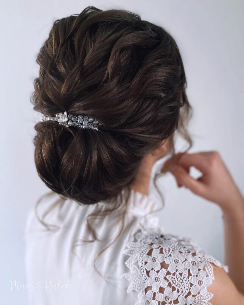 This low bun hairstyle works best with medium-length hair that has some natural texture, as it adds volume and body to the bun.