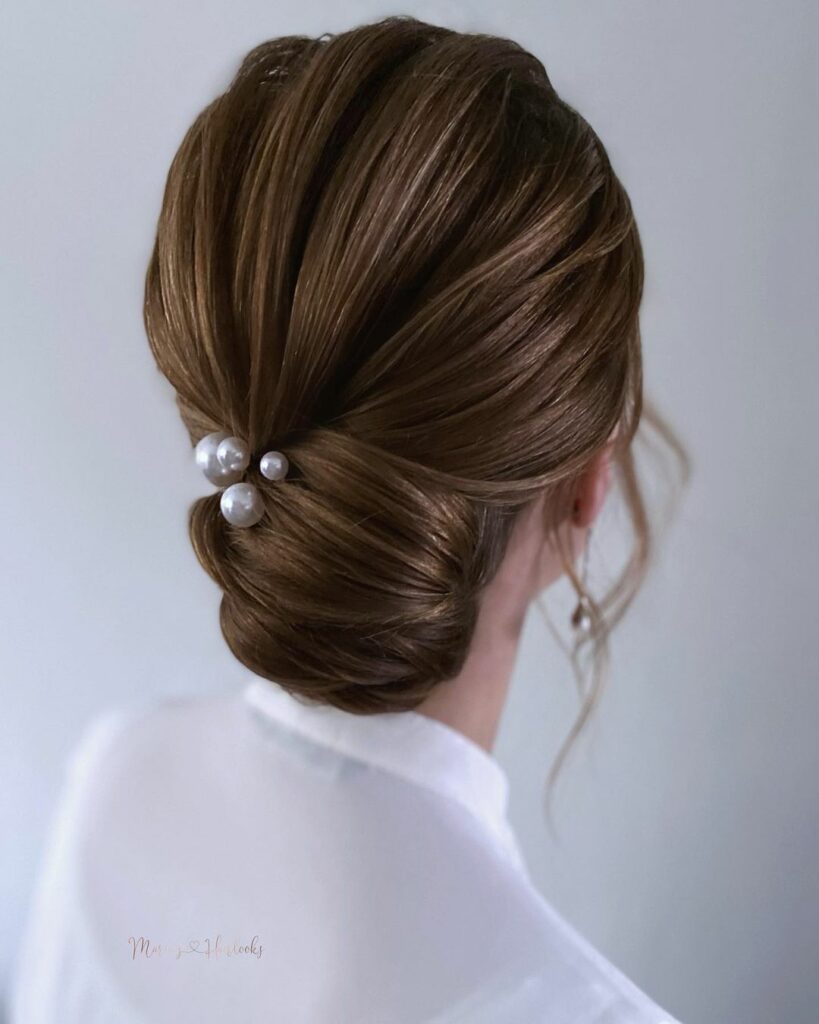 This low-maintenance medium wedding hairstyle will keep your hair secure and out of your face, allowing you to enjoy your special day without any fuss.