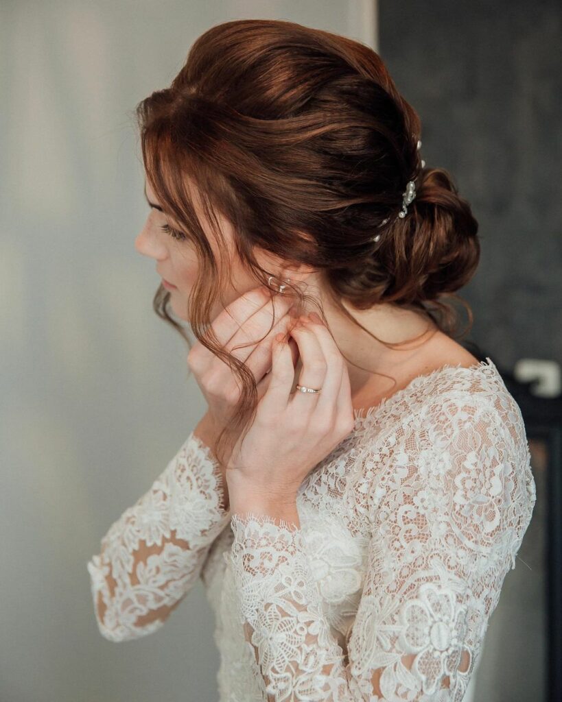 The twisted low bun wedding hairstyle for medium hair is versatile and can be styled to suit any wedding dress style, from bohemian to traditional.