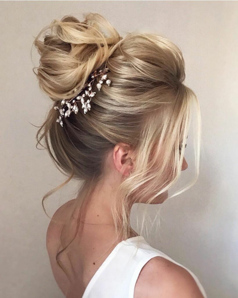 This messy bun medium length hairstyle is perfect for brides who want a chic yet casual look.