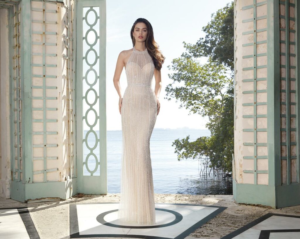 If you want to look like a queen on your wedding day, a stunning sheath gown with a halter neckline is the way to go.