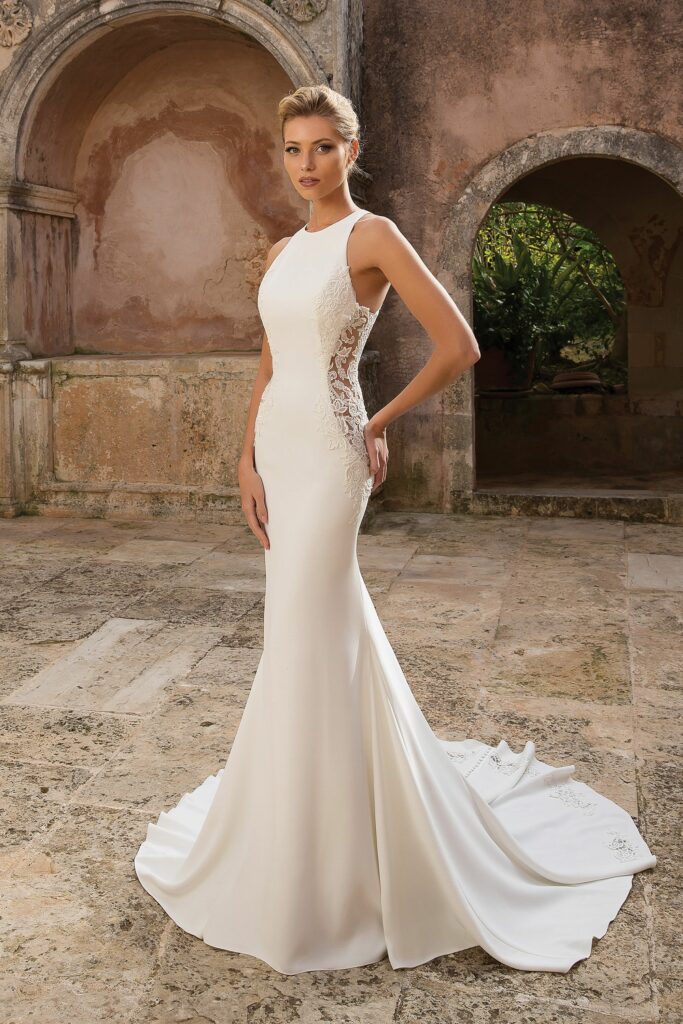 It's easy to look sexy in a crepe fit-and-flare wedding dress with illusion lace side cutouts.