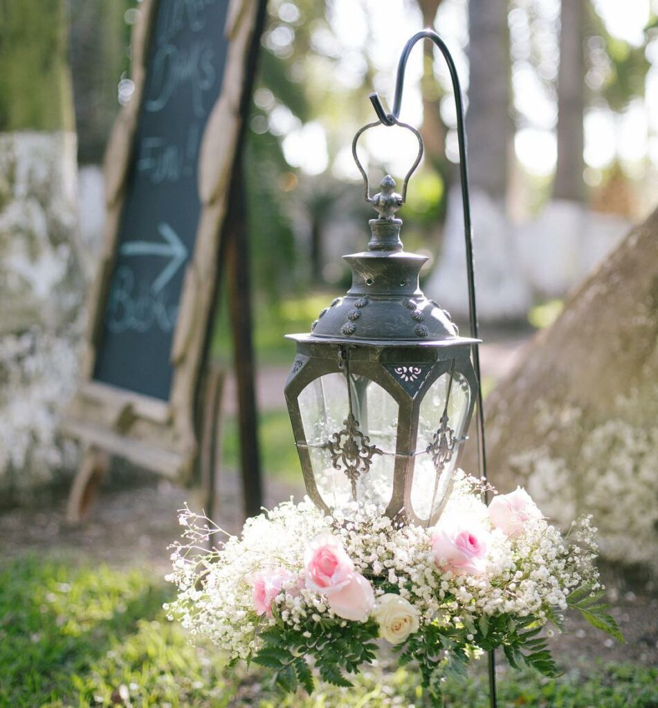 A weddings hanging lanterns centerpiece is sure to grab guests eyes even if the lanterns themselves arent on the table