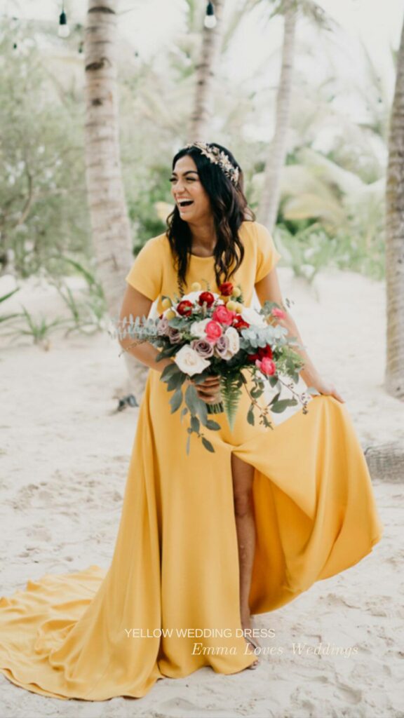 A bright yellow A line wedding dress with short sleeves and a slit along the front for the blushing bride.