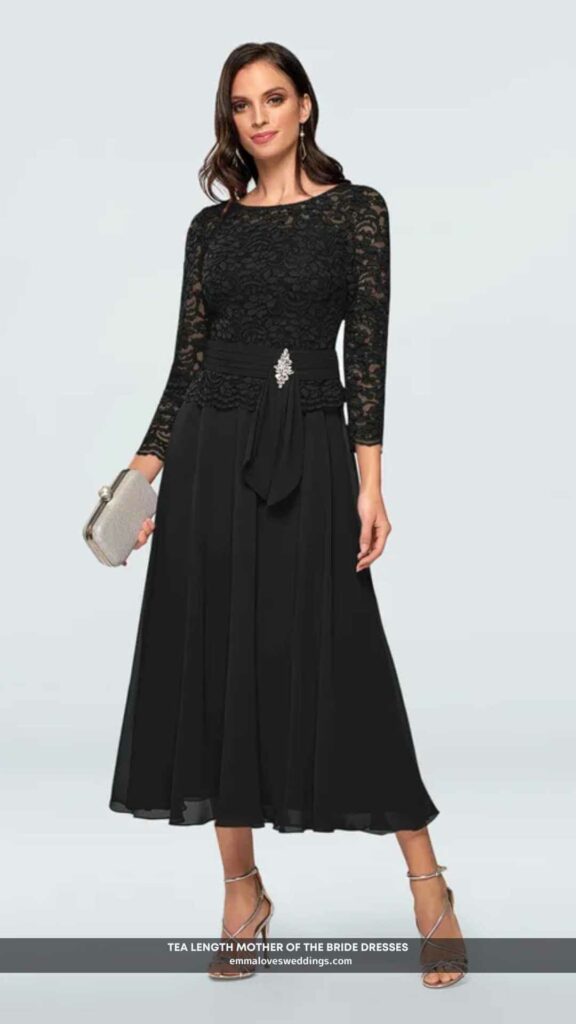 A mother of the bride dress that is sophisticated in black chiffon and lace and is tea length.