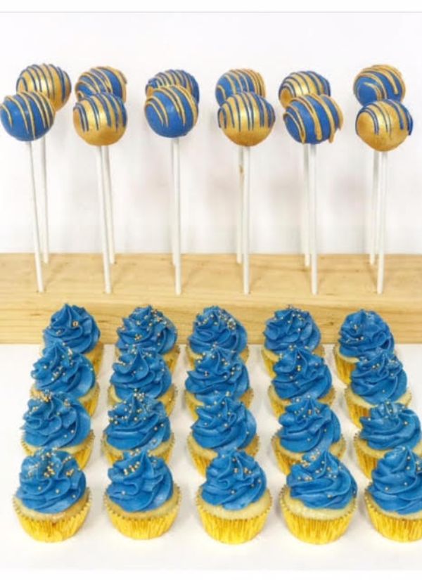 A striking addition to a blue dessert table would be these wedding cake pops decorated in blue and gold.
