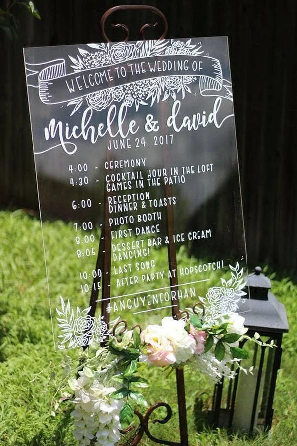 Acrylic wedding welcome sign with a timeline of the day