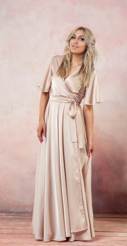 Champagne floor length flutter sleeved bridesmaid dress ideal for a wedding with a relaxed bohemian feel.