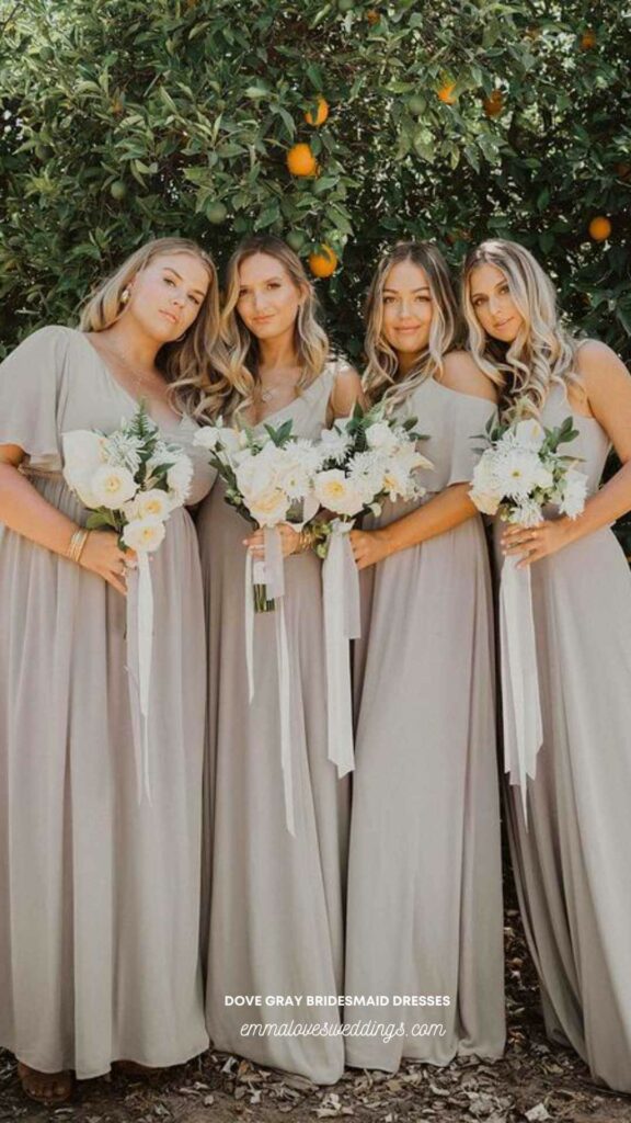 Dove grey bridesmaid dresses paired with a white bouquet are a beautiful and elegant idea.