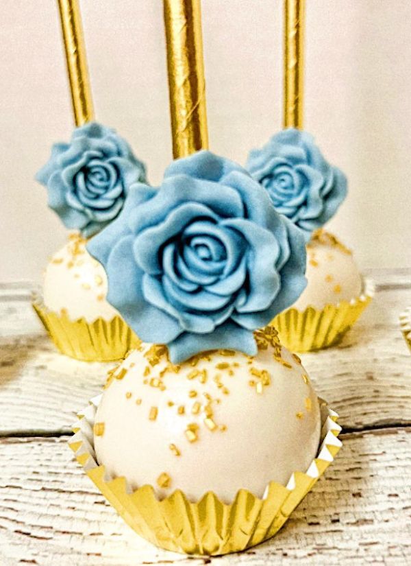 Love this stunning rose and wedding cake pops Dusty blue eucalyptus and gold are elegant wedding colors.