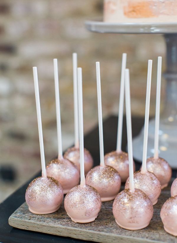 Pink cake pops with gold accents will add a touch of radiance to your wedding event.